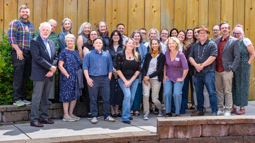 A large group poses outside.