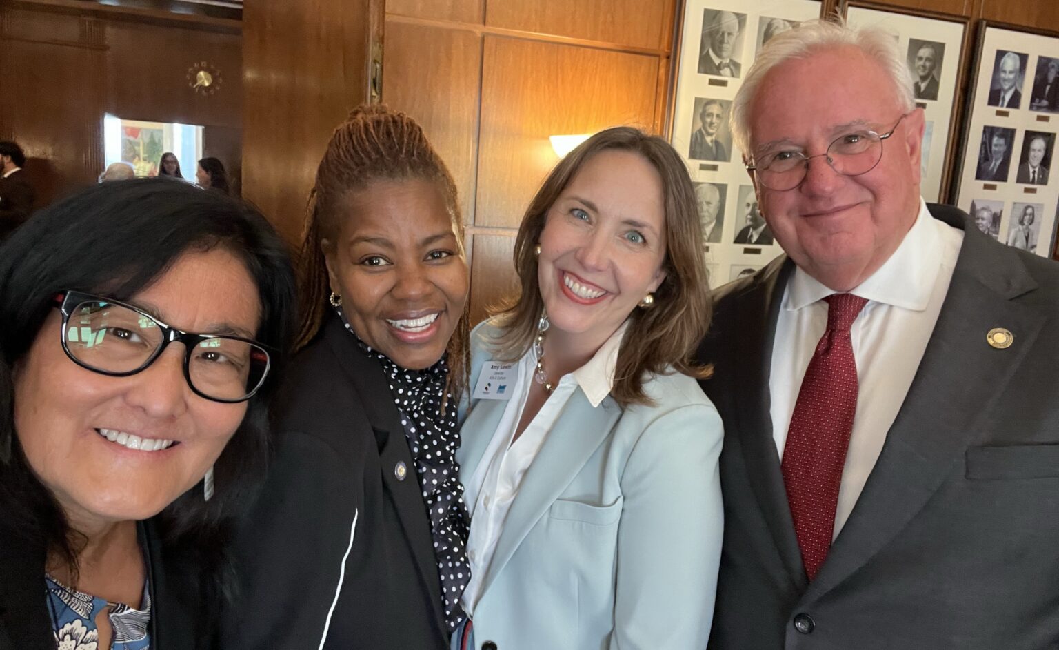 A group of four poses for a selfie in the Oregon Governor's Ceremonial Office.