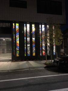 Evening light shows off the glass art John Tess created for Portland's Muse apartment complex.