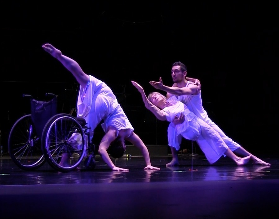 Dancers, including one in a wheelchair, perform.